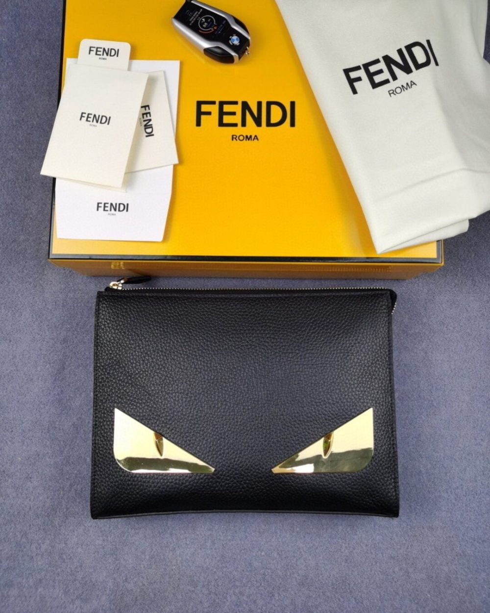 1:1 Replica Fendi Monster Eyes Flat Zip Pound Clutch in Black with Gold Toned Hardware For Men 27cm/10.5in FF